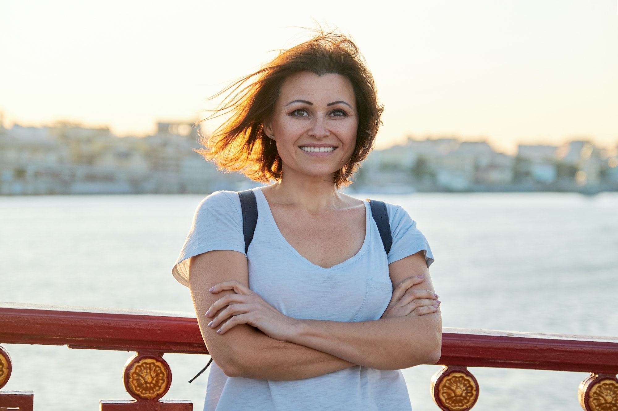 Outdoor portrait of positive smiling middle-aged woman